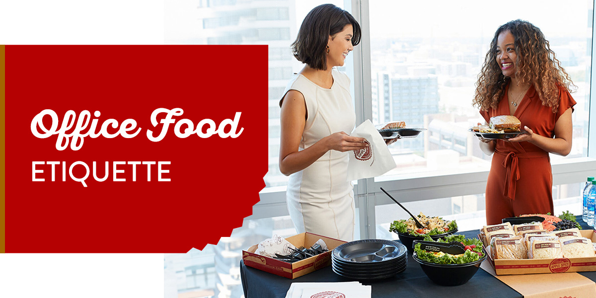 two women enjoying corporate catering and showing office food etiquette