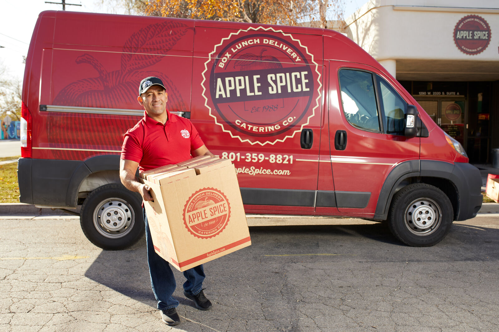 delivery man delivering box lunch catering to a college campus