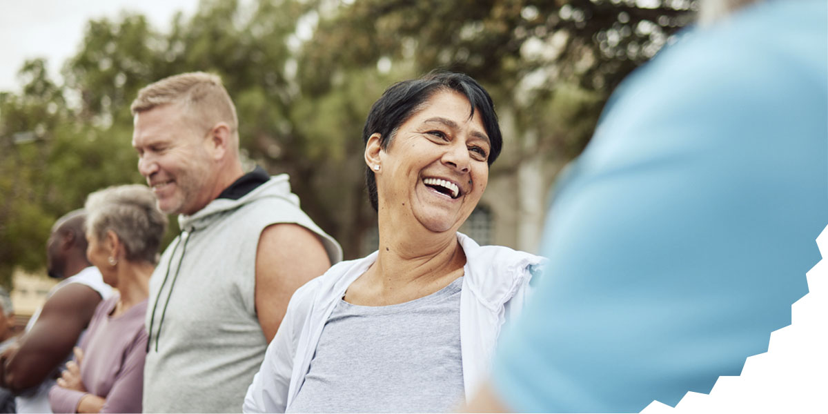 Adults smiling and laughing during a team-building activity at work.